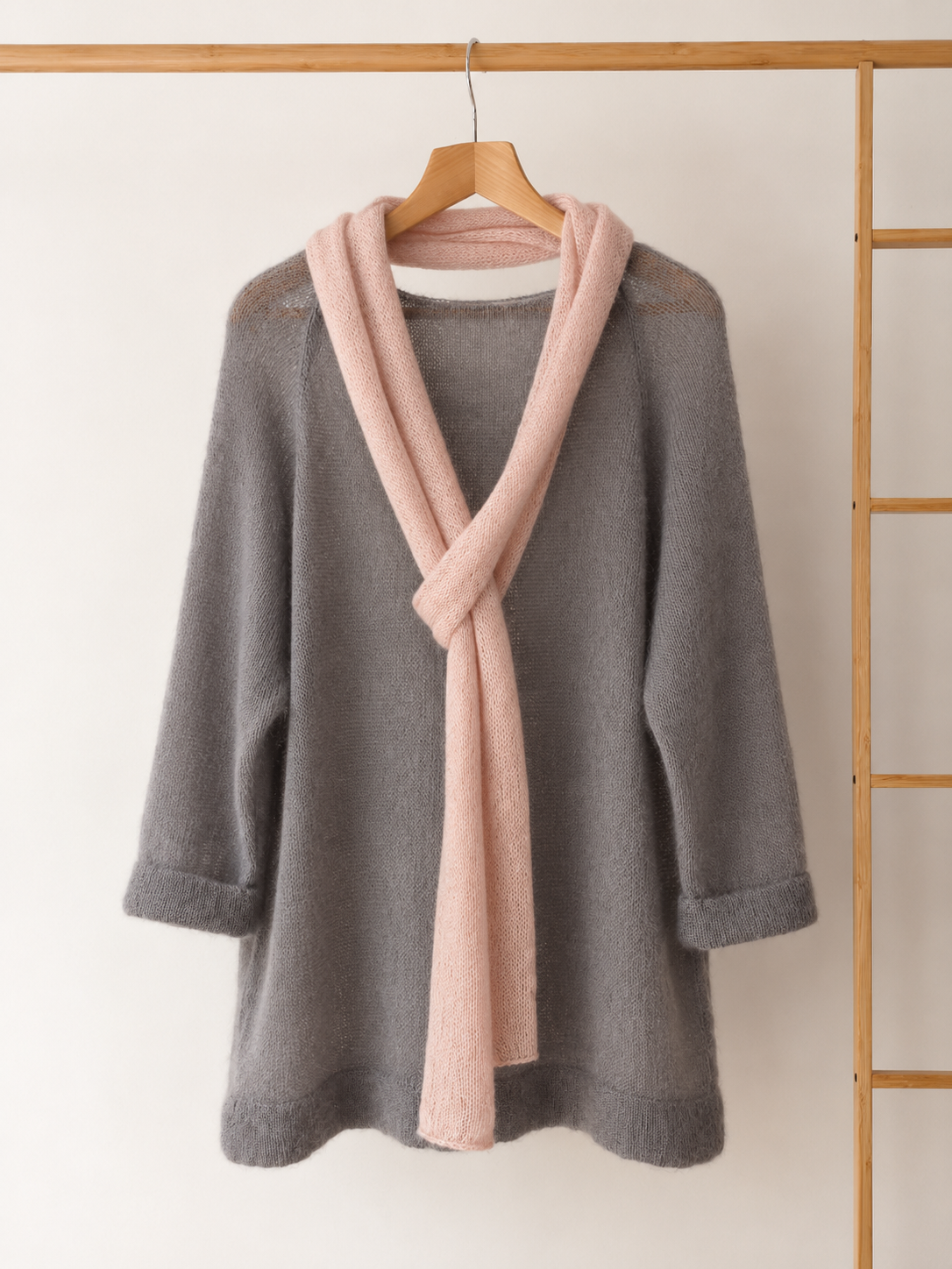 Pink skinny scarf styled over grey knit sweater