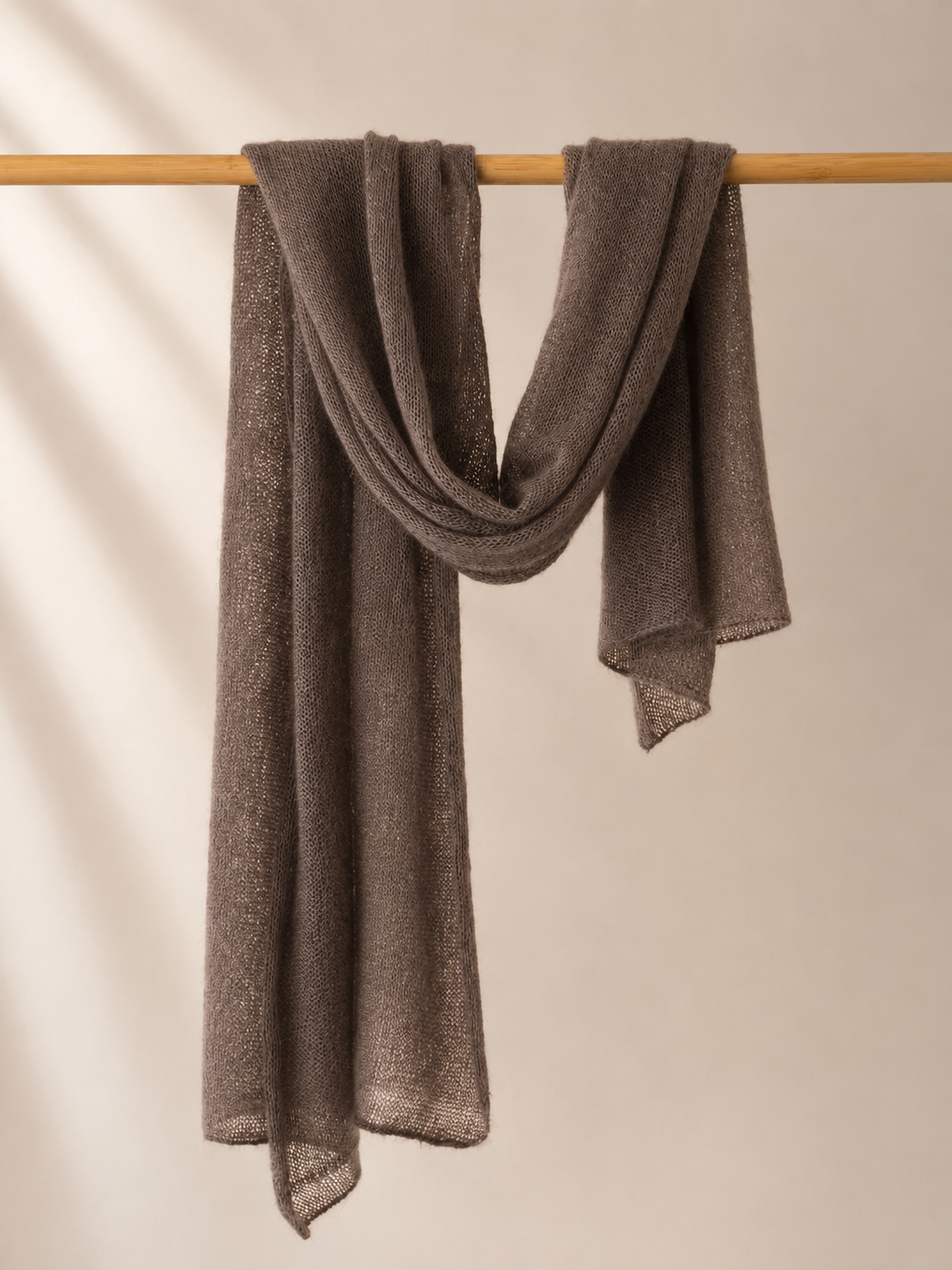 Warm Taupe silk mohair shawl draped over a wooden rail in soft elegant folds