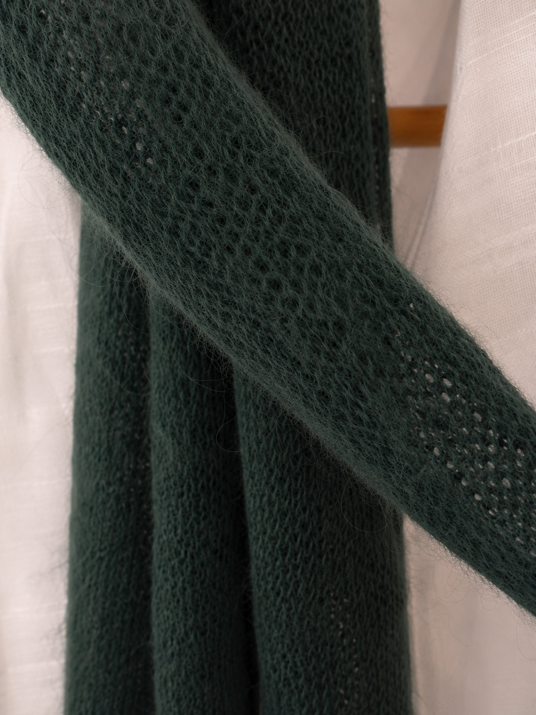 Macro detail showing the soft natural halo of a handmade kid mohair scarf.