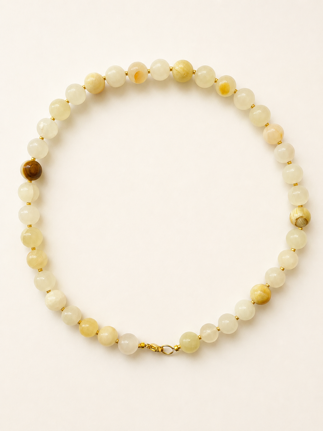 Cream yellow jadeite necklace with 10mm beads, gold Miyuki spacers and a golden lobster clasp
