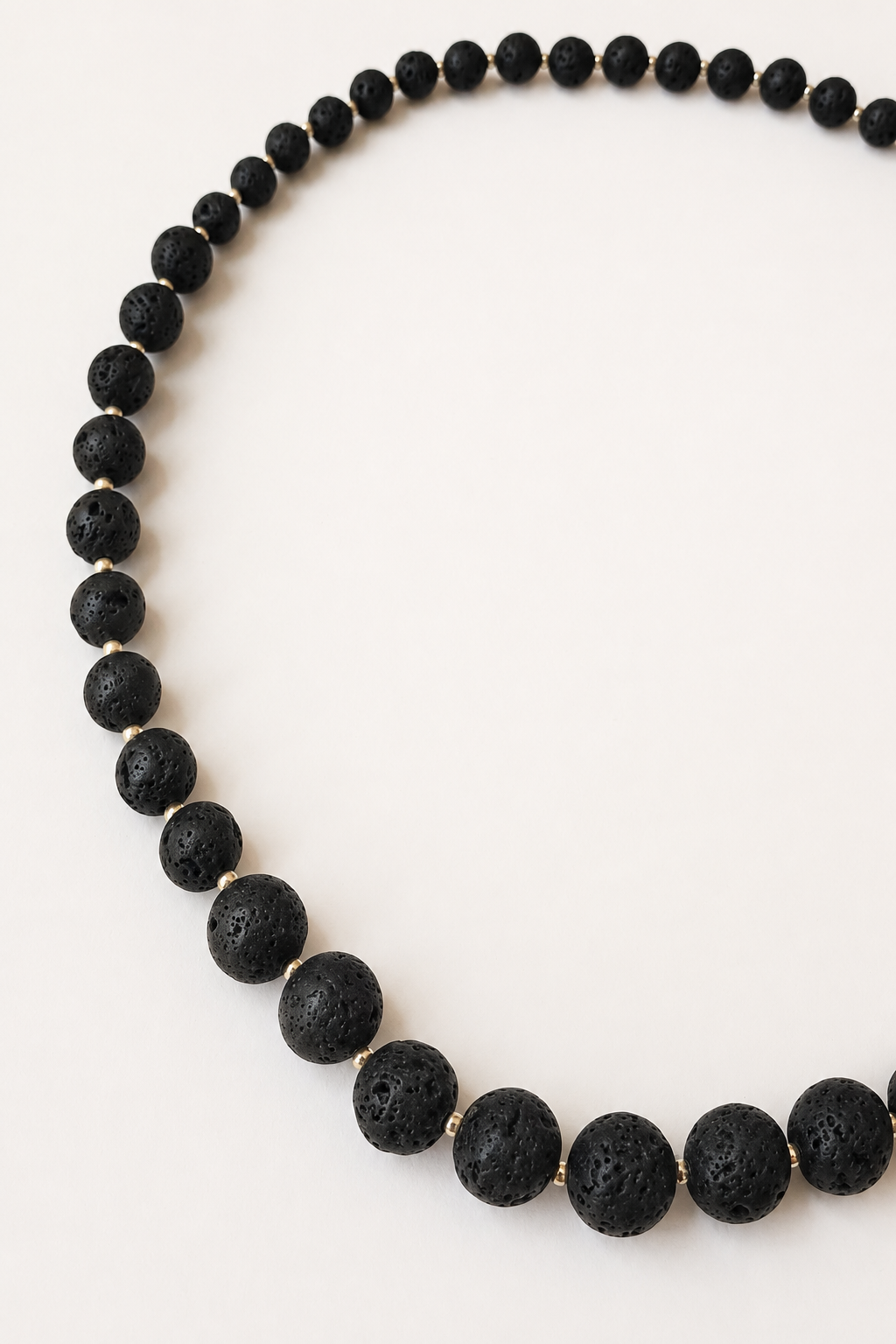 Full black lava stone necklace showing graduated bead sizes and silver Miyuki spacers