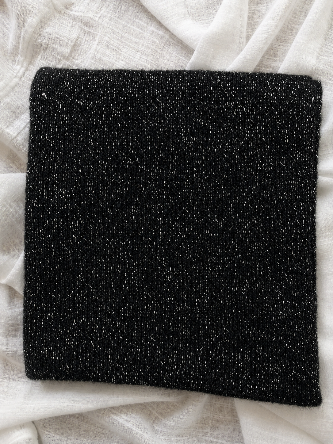 Close-up of black mohair knit with fine silver metallic threads