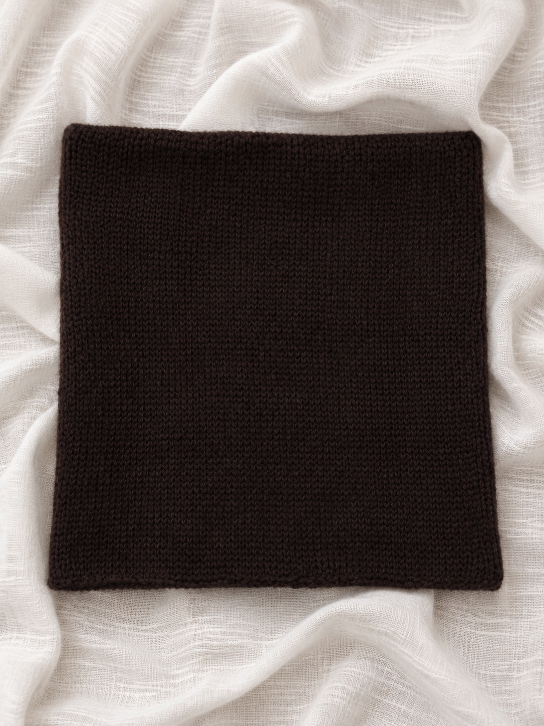 Folded Dark Brown silk mohair infinity scarf showing knit texture.