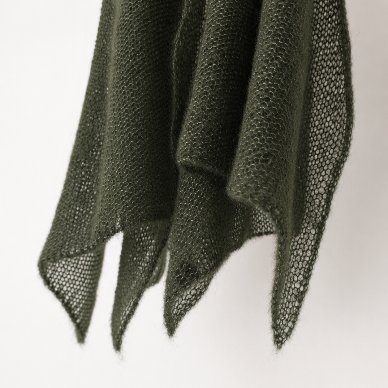 Close-up of the Moss Whisper silk mohair shawl showing its delicate knit structure and naturally soft mohair halo