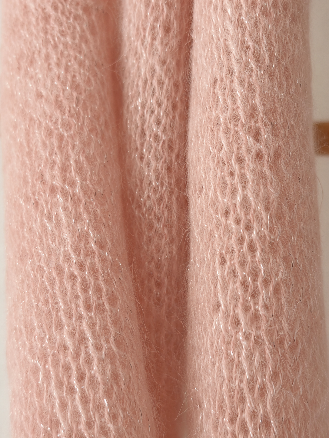 Macro detail of fluffy lightweight knitted scarf fibres