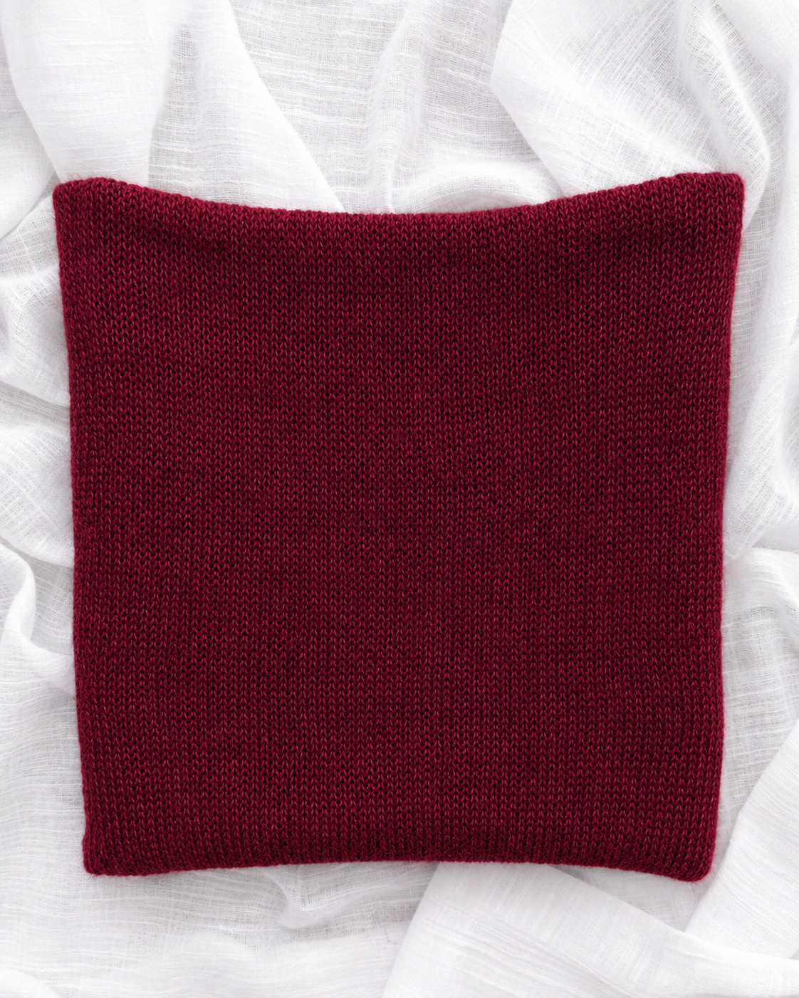 Flat lay of Burgundy infinity scarf.