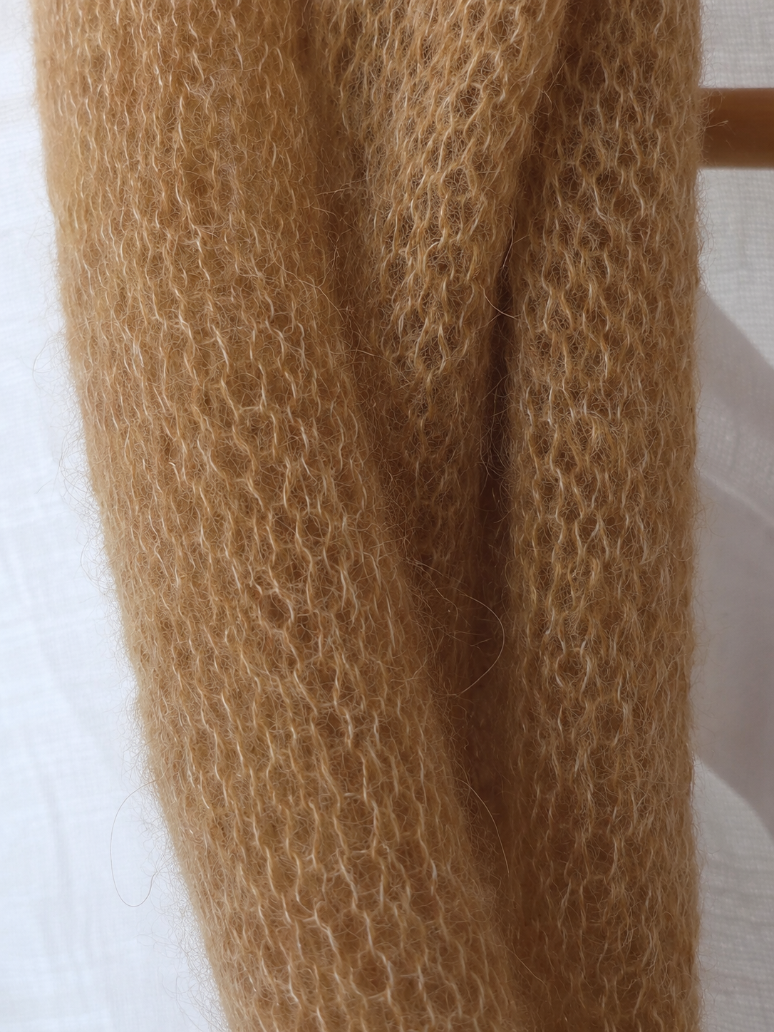 Macro detail showing the soft fluffy halo of Warm Camel kid mohair fibres.