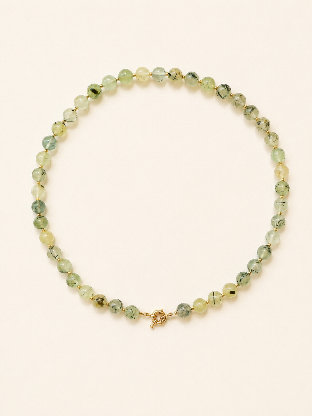 Prehnite necklace with translucent pale green beads, natural dark inclusions and gold accents