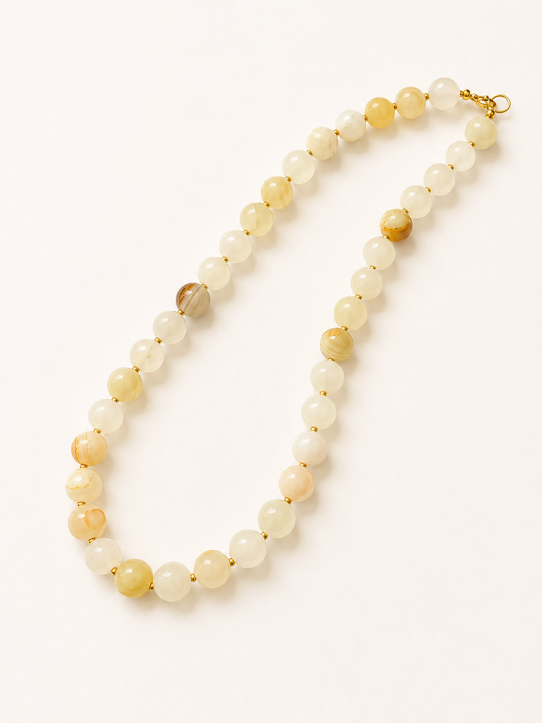 Long jadeite necklace arrangement with ivory, butter yellow and patterned 10mm beads