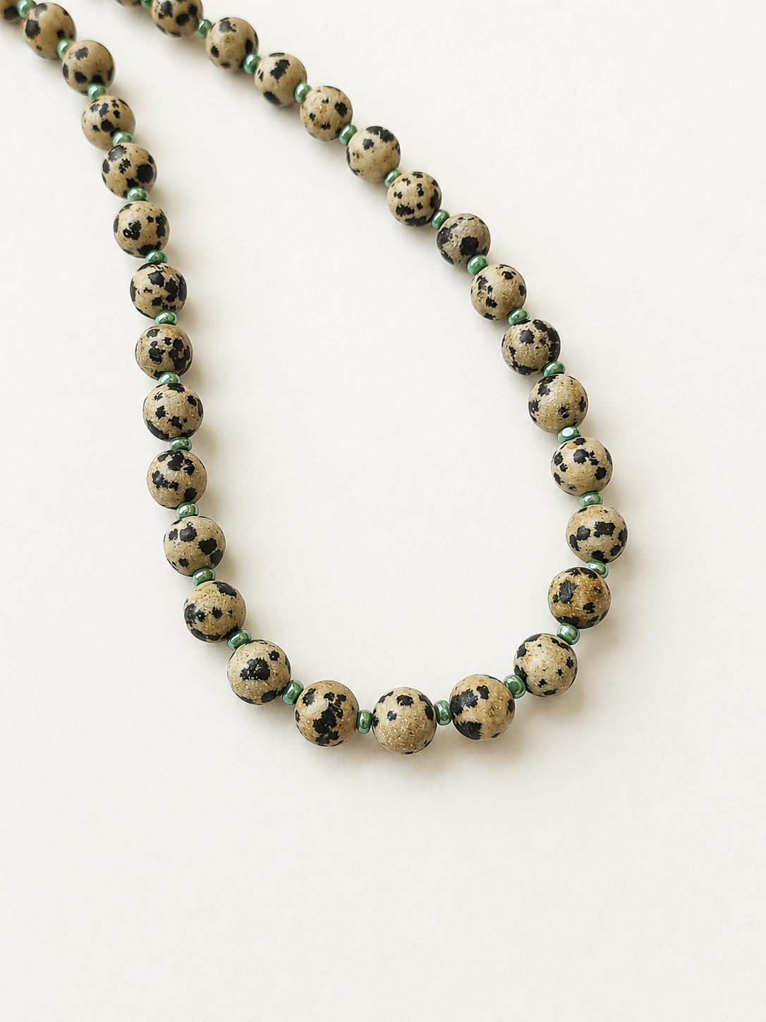 Dalmatian jasper necklace arranged to show the individual natural markings of each stone bead