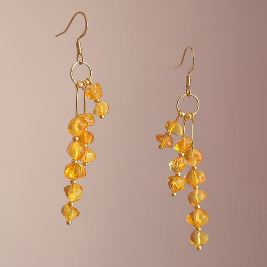 long baltic amber earrings with golden details ant stainless steel hooks