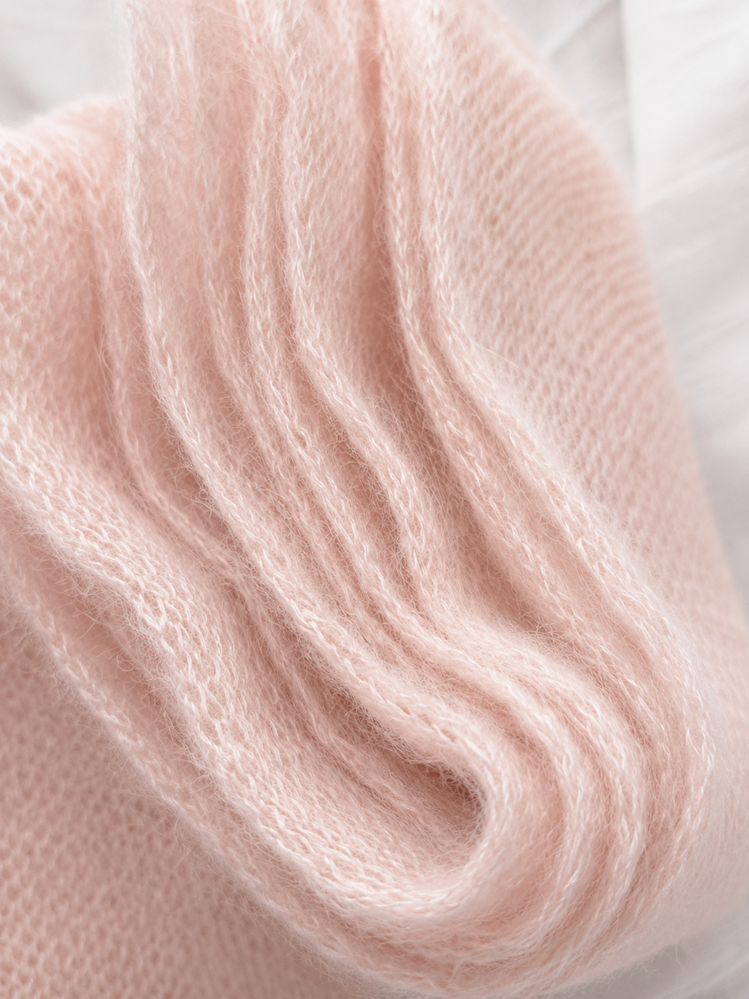Macro view of the soft mohair fibres on the Blush Pink scarf.