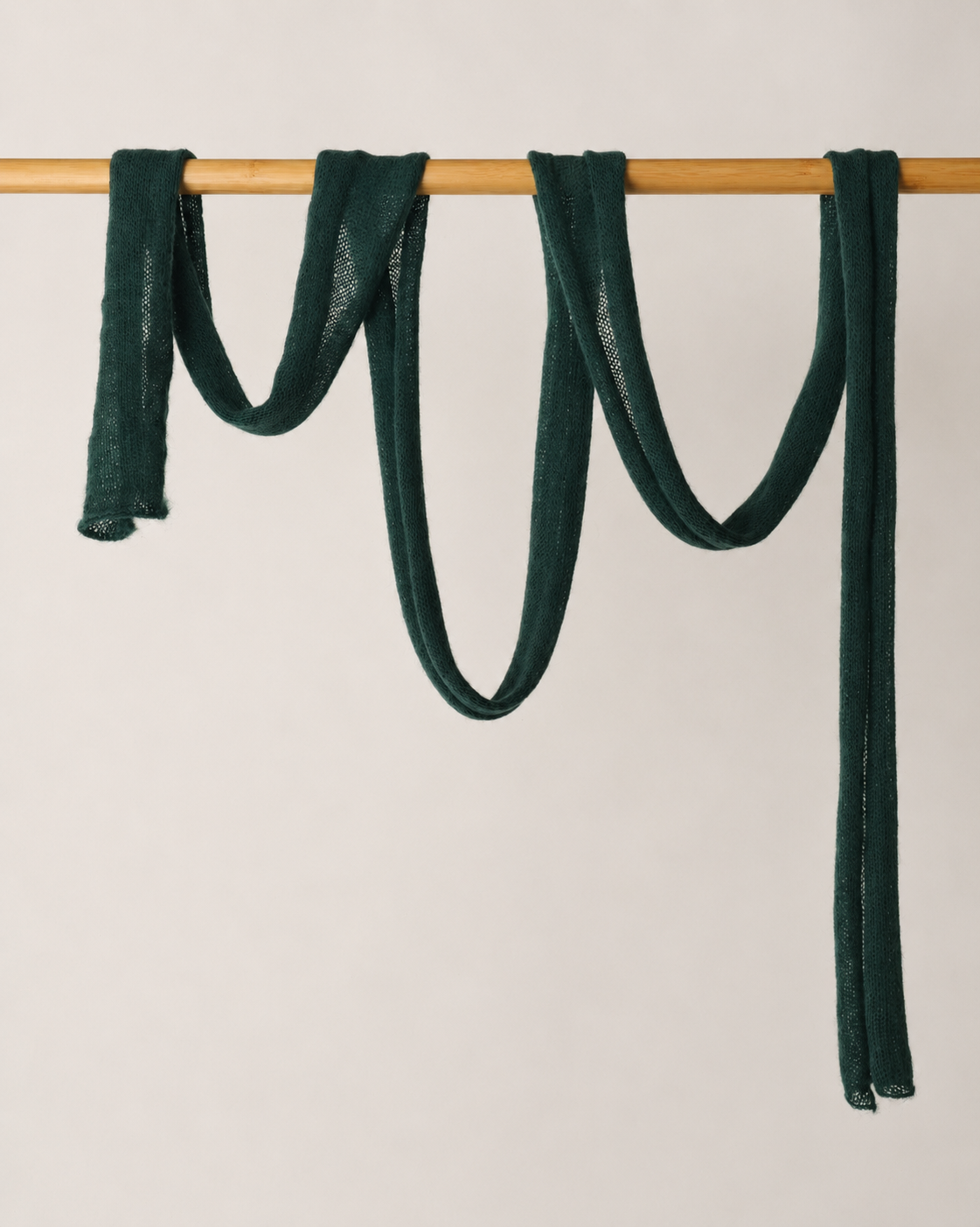 Full-length extra-long forest green kid mohair scarf draped over a wooden rail.