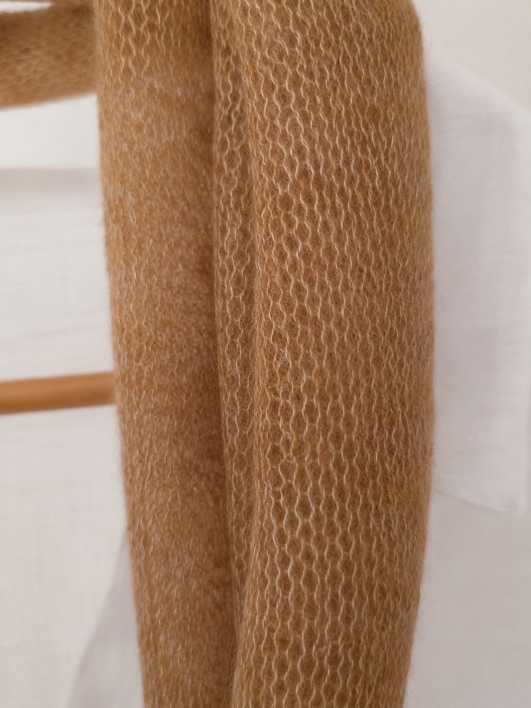 Close-up of the open knit texture of a Warm Camel kid mohair scarf.