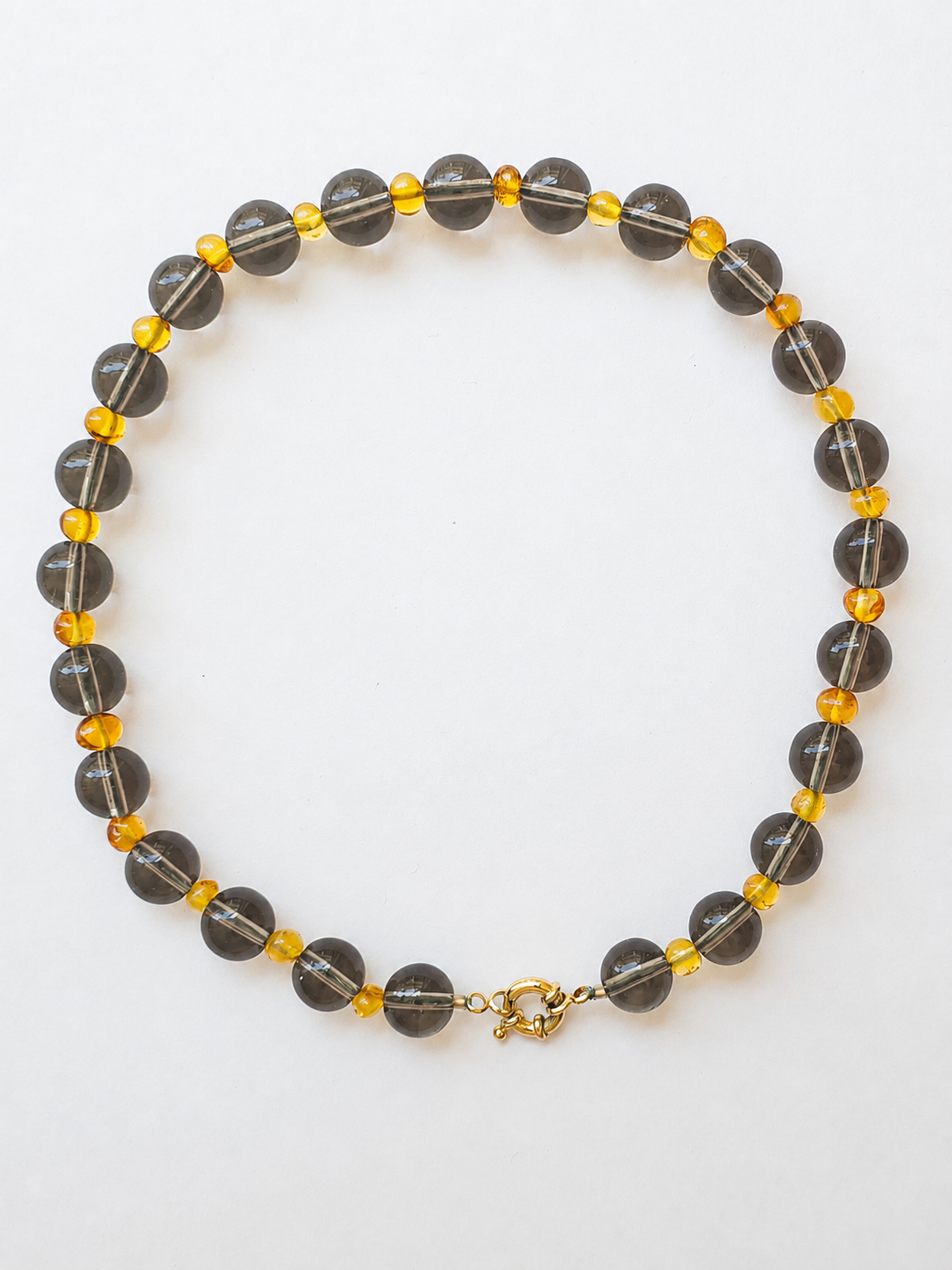 Smoky quartz and Baltic amber necklace with large round grey beads and warm honey amber accents