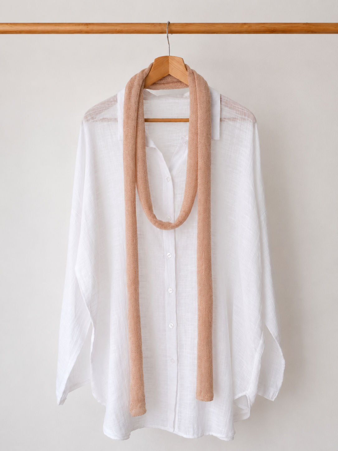 Blush Sand extra long kid mohair skinny scarf styled on a white linen shirt