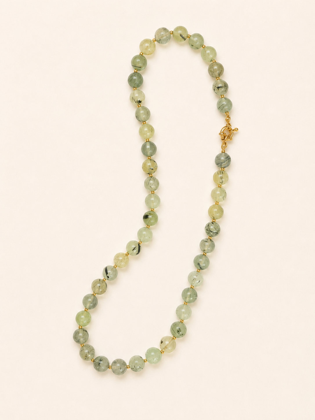 Full-length arrangement of a 45cm prehnite gemstone necklace with a golden spring ring clasp