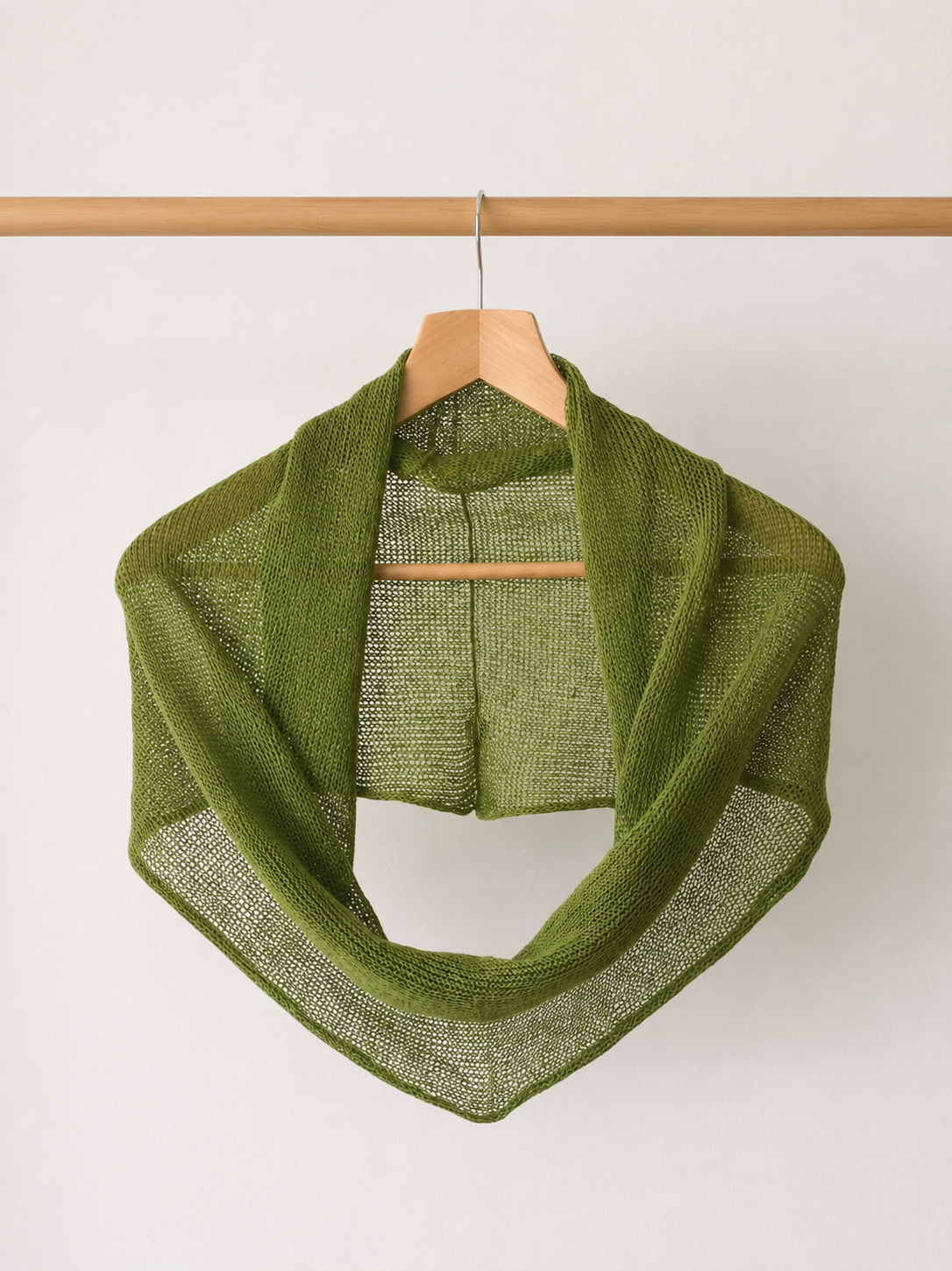 Olive Green 100% linen infinity scarf hanging on a wooden hanger.