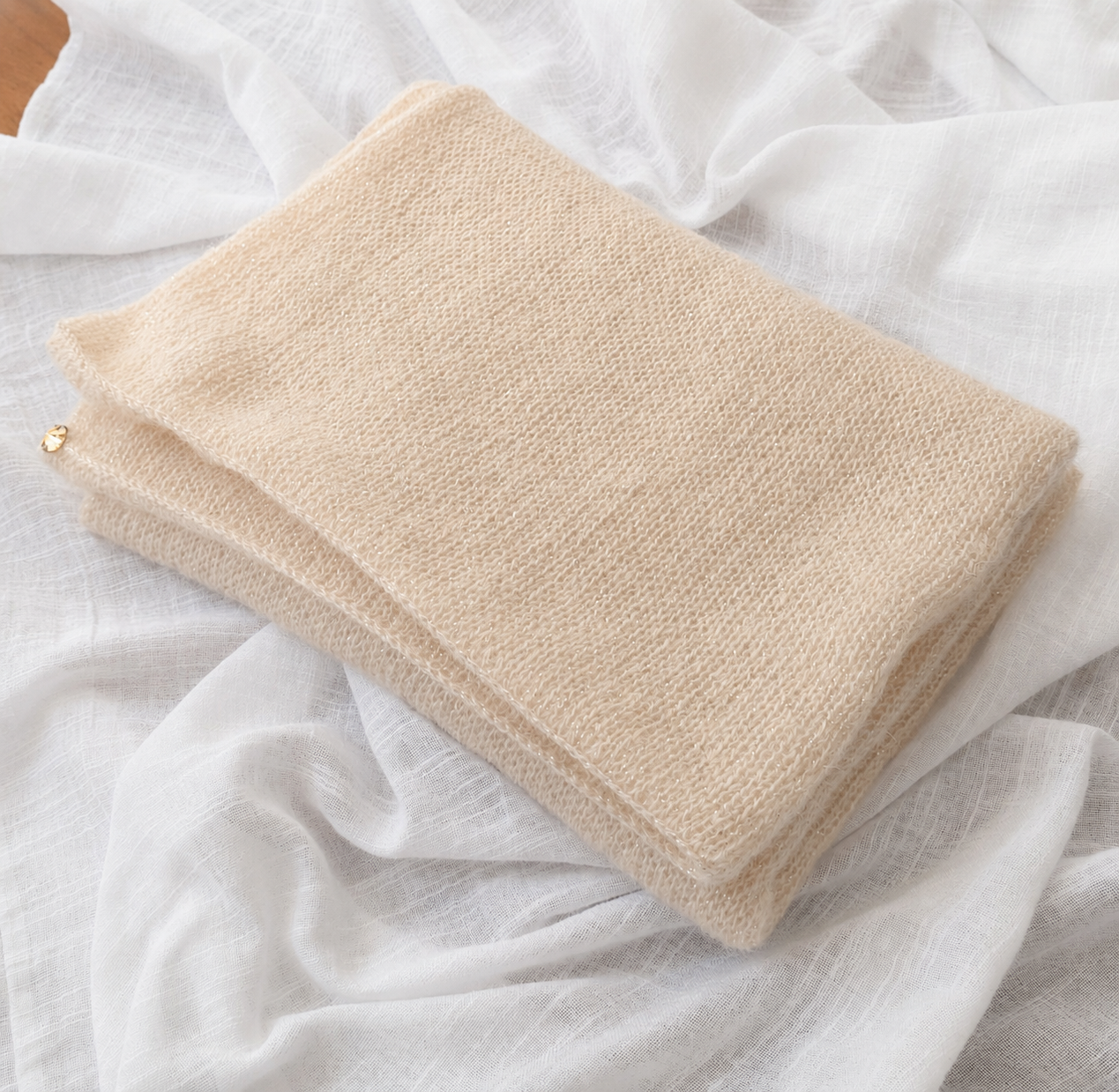 Close-up of the knitted texture and subtle shimmer of the Light Champagne Infinity Scarf.