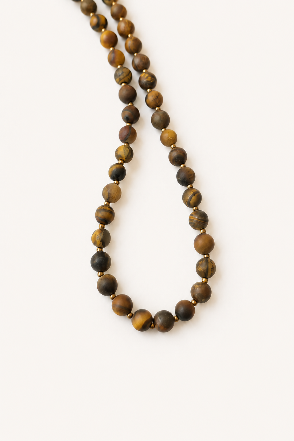 Full 42cm matte tiger eye necklace arranged lengthwise to show the natural variation of the beads