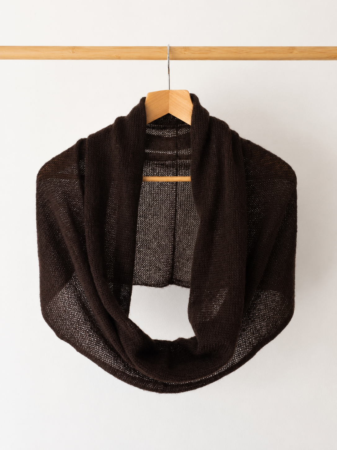 Dark Brown silk mohair infinity scarf hanging on a wooden hanger.
