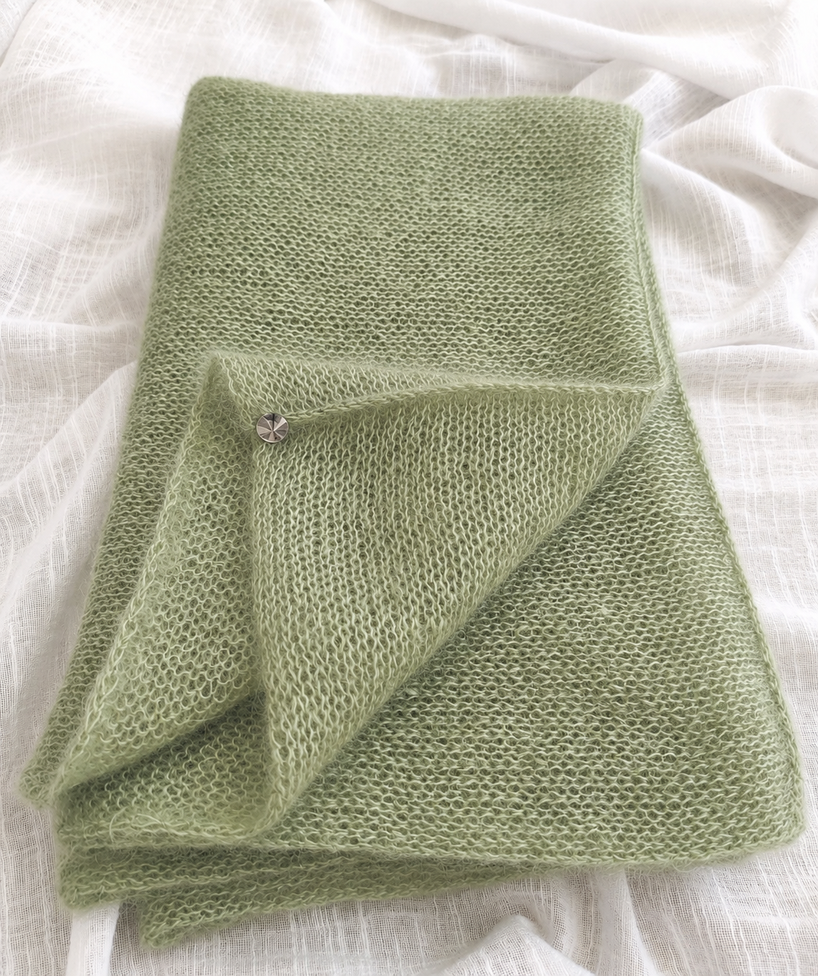 Folded Soft Sage mohair scarf with decorative crystal detail.