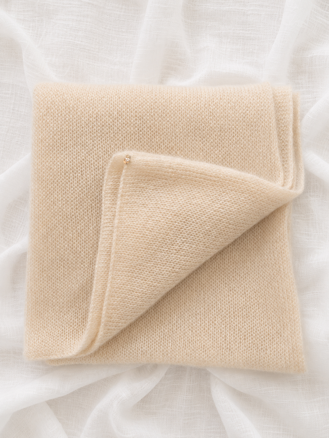 Folded Light Champagne Infinity Scarf showing its soft knitted texture.