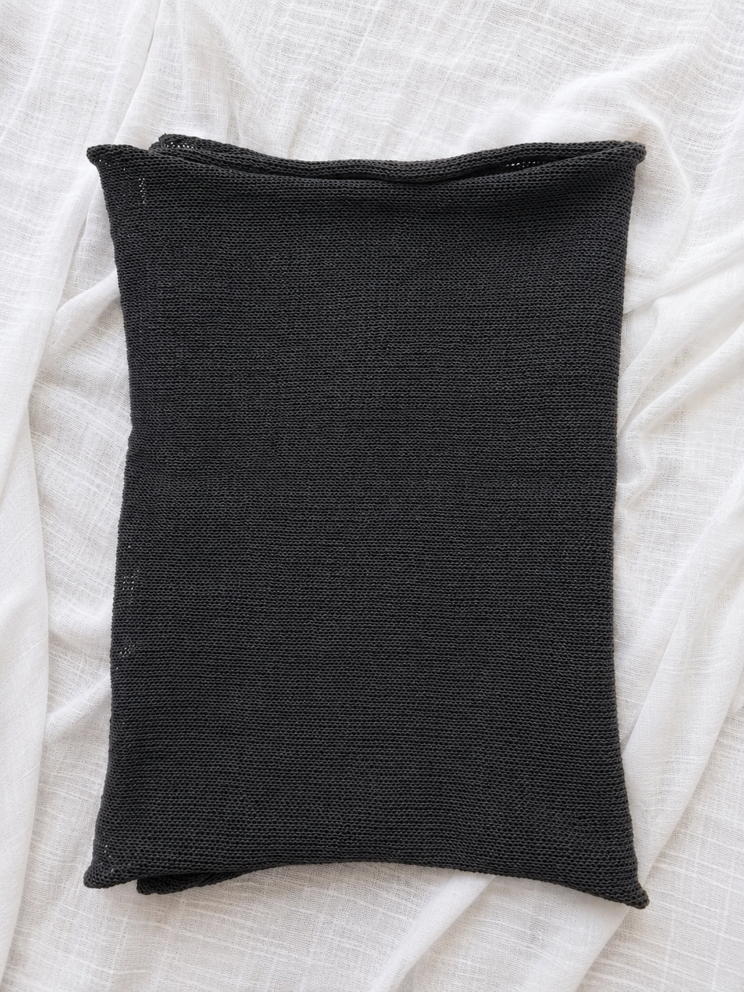 Folded Charcoal Grey linen blend scarf displaying its elegant knit texture.