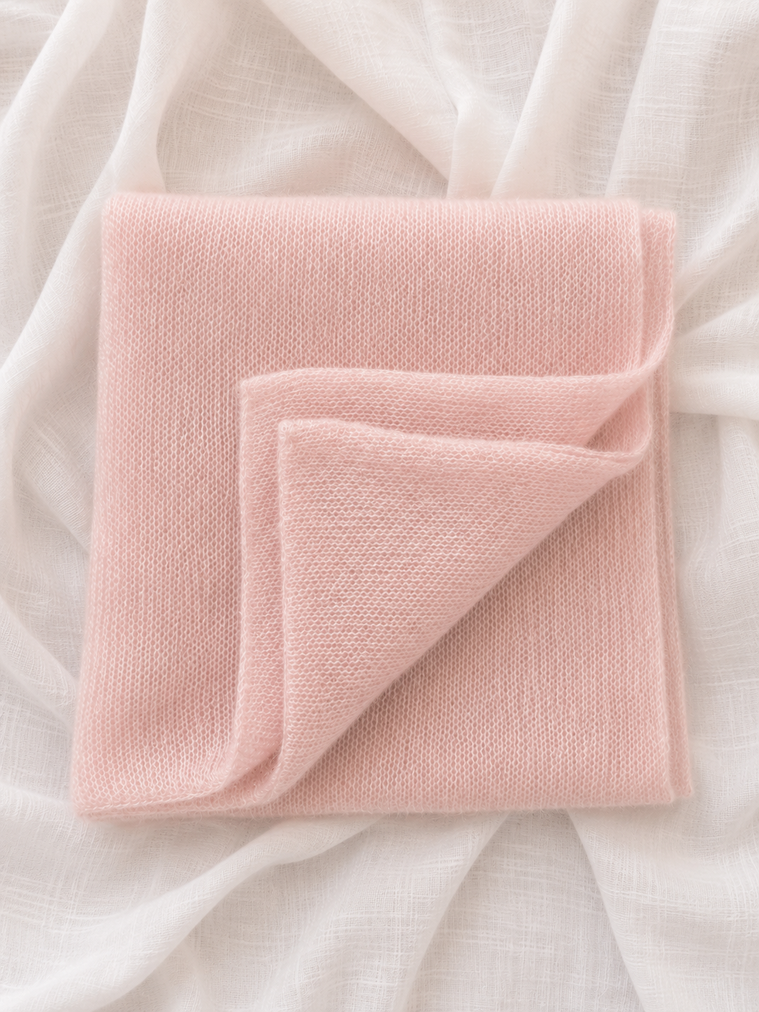 Folded Blush Pink Infinity Scarf showing its soft knitted texture.