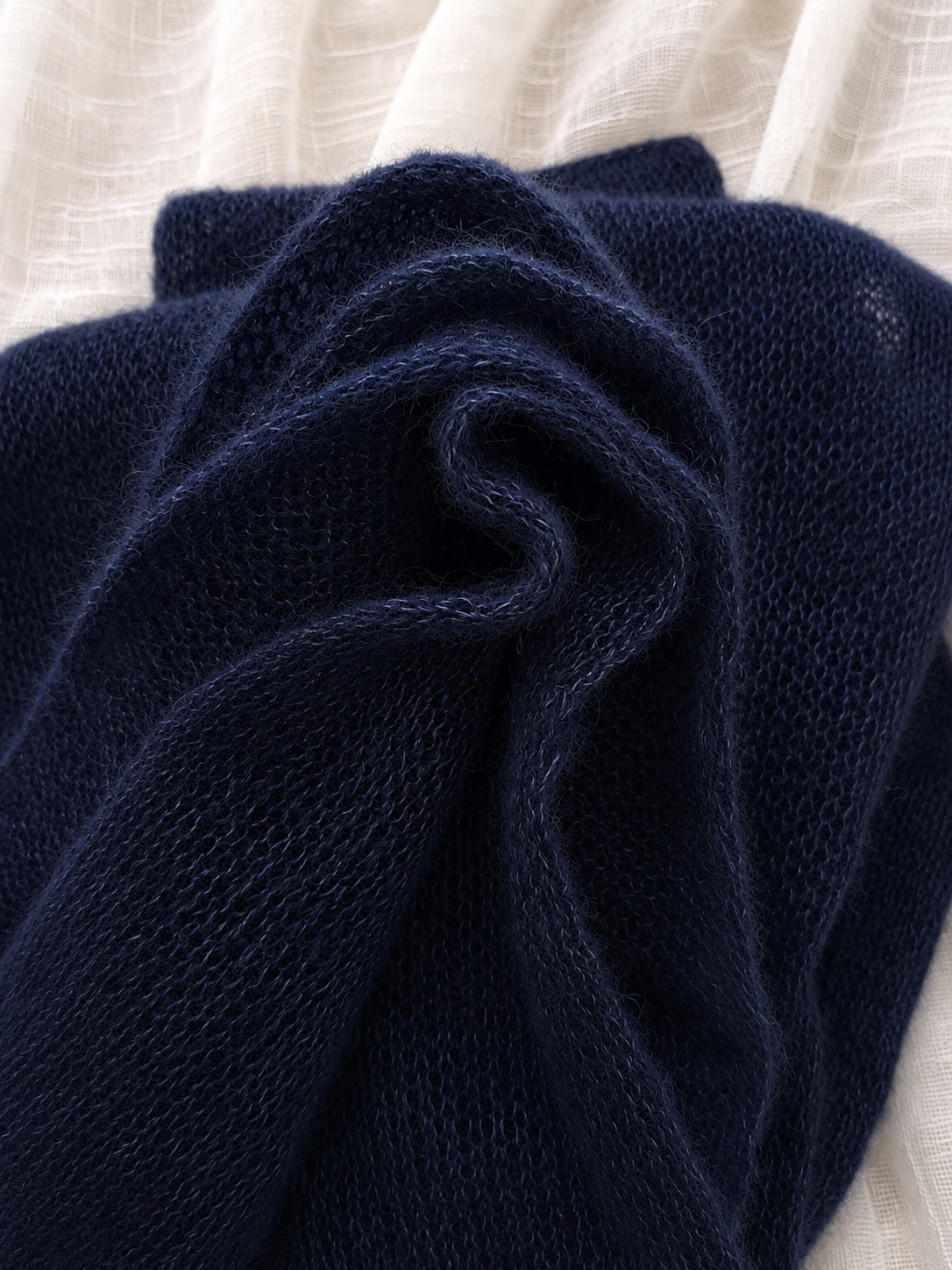 Close-up of the soft mohair halo on a navy infinity scarf.