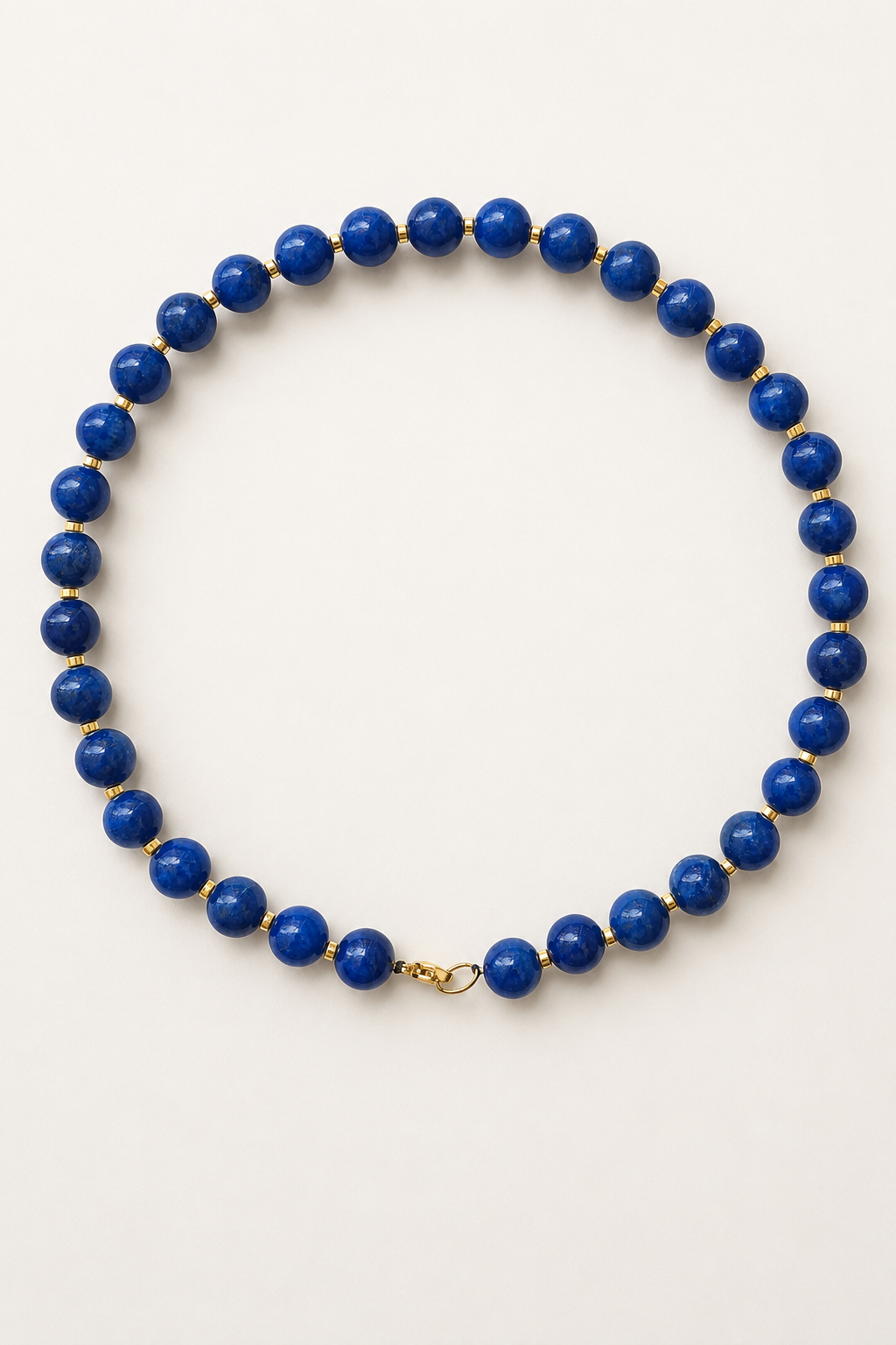 Royal blue jadeite necklace with 10mm beads, gold hematite spacers and a golden lobster clasp
