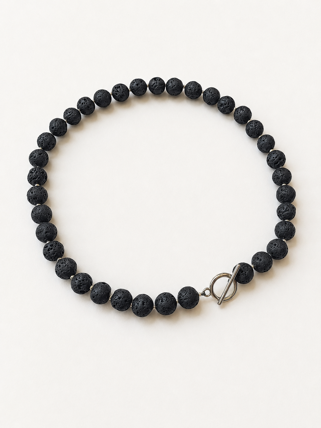 Black lava stone necklace with 10mm textured beads, silver accents and a stainless steel toggle clasp