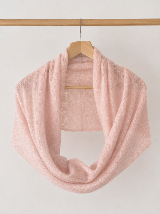 Blush Pink Infinity Scarf hanging on a wooden hanger.
