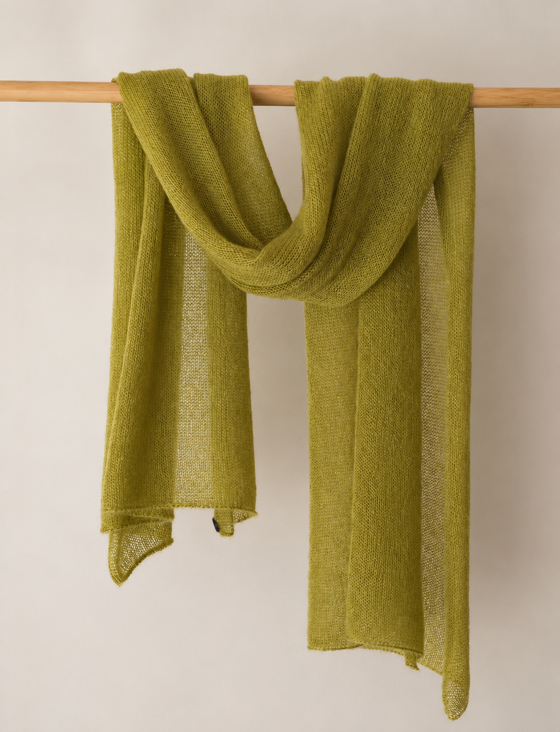 Moss Olive silk mohair shawl draped over a wooden rail in soft elegant folds