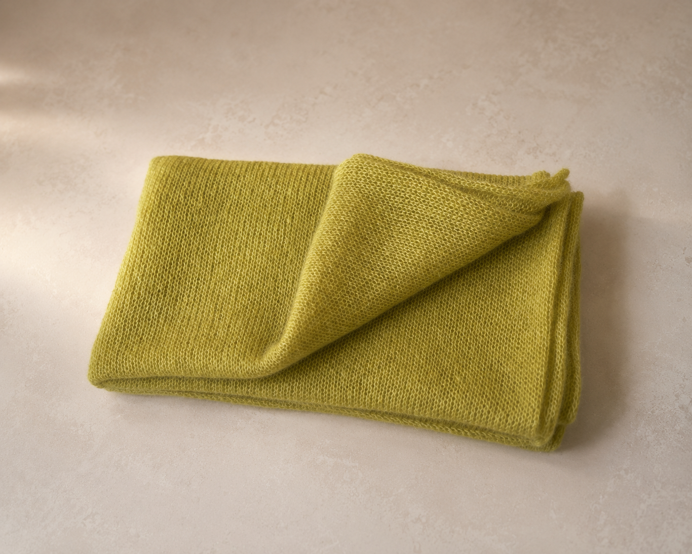 Folded Moss Olive silk mohair shawl highlighting its soft airy texture