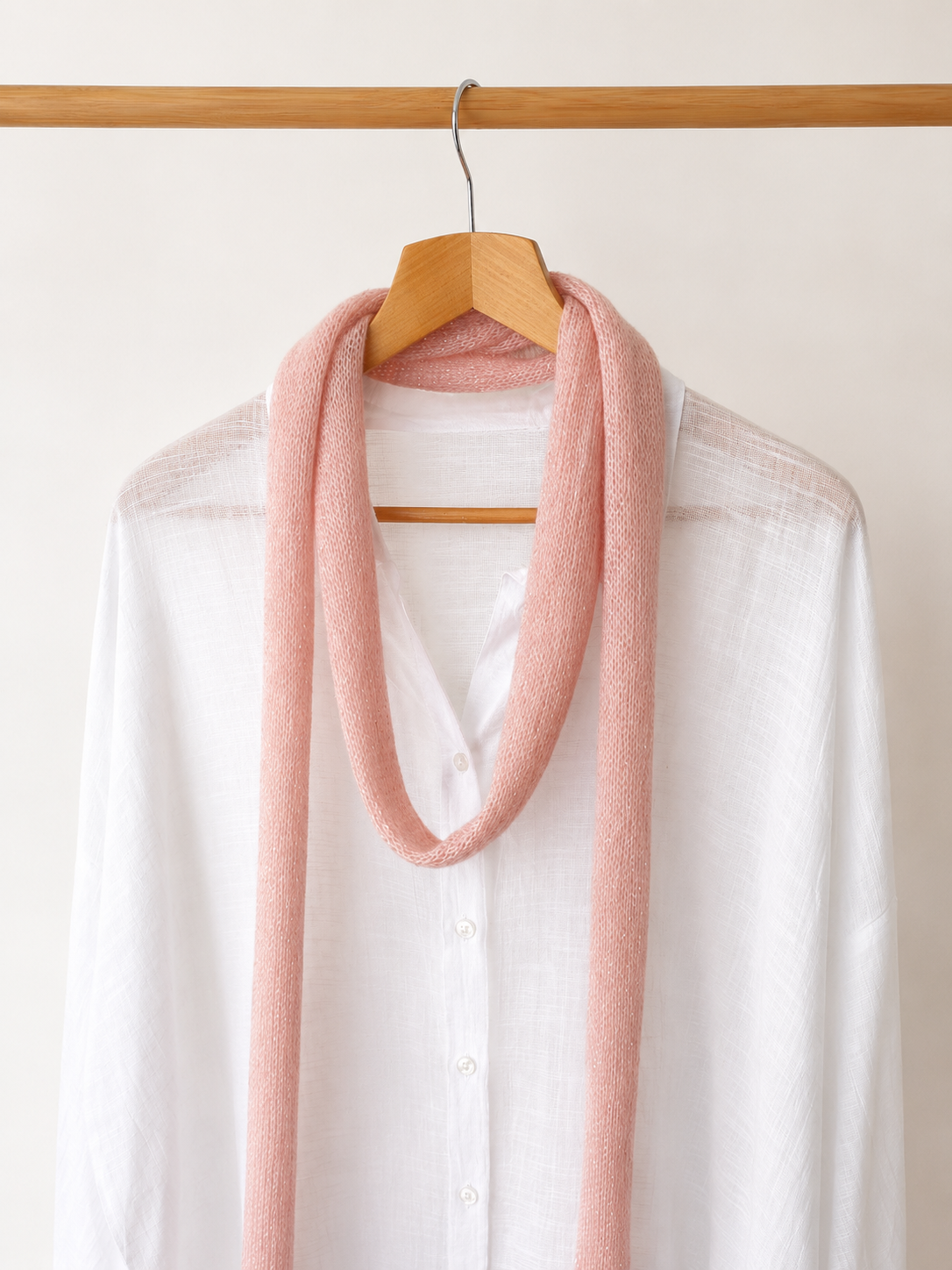 Handmade pink skinny scarf close-up soft knit texture