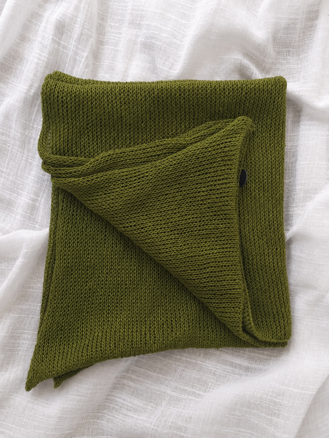 Folded Olive Green 100% linen infinity scarf showing knit texture.