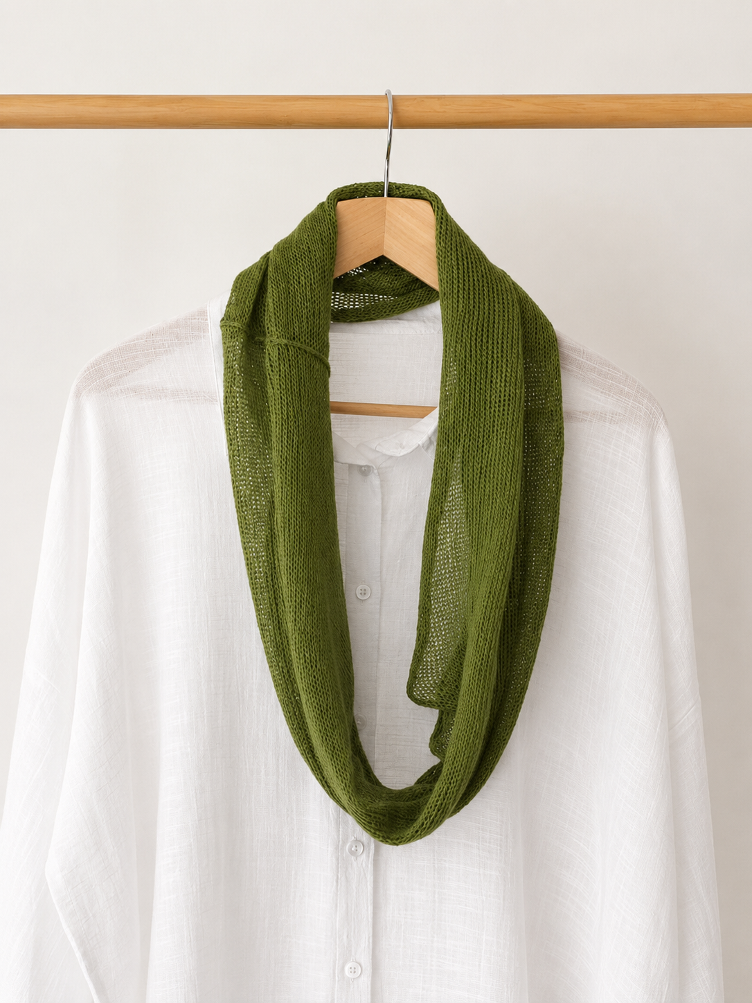 Lightweight Olive Green linen loop scarf wrapped around the neck.