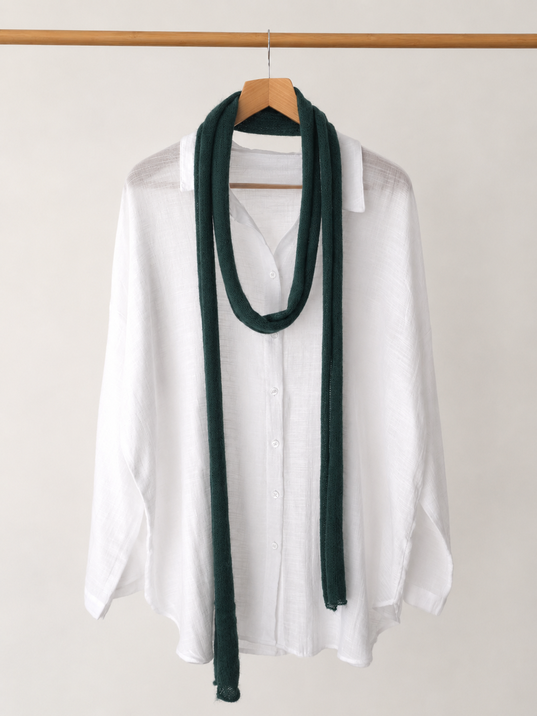 Deep forest green handmade kid mohair skinny scarf styled over a white linen shirt.