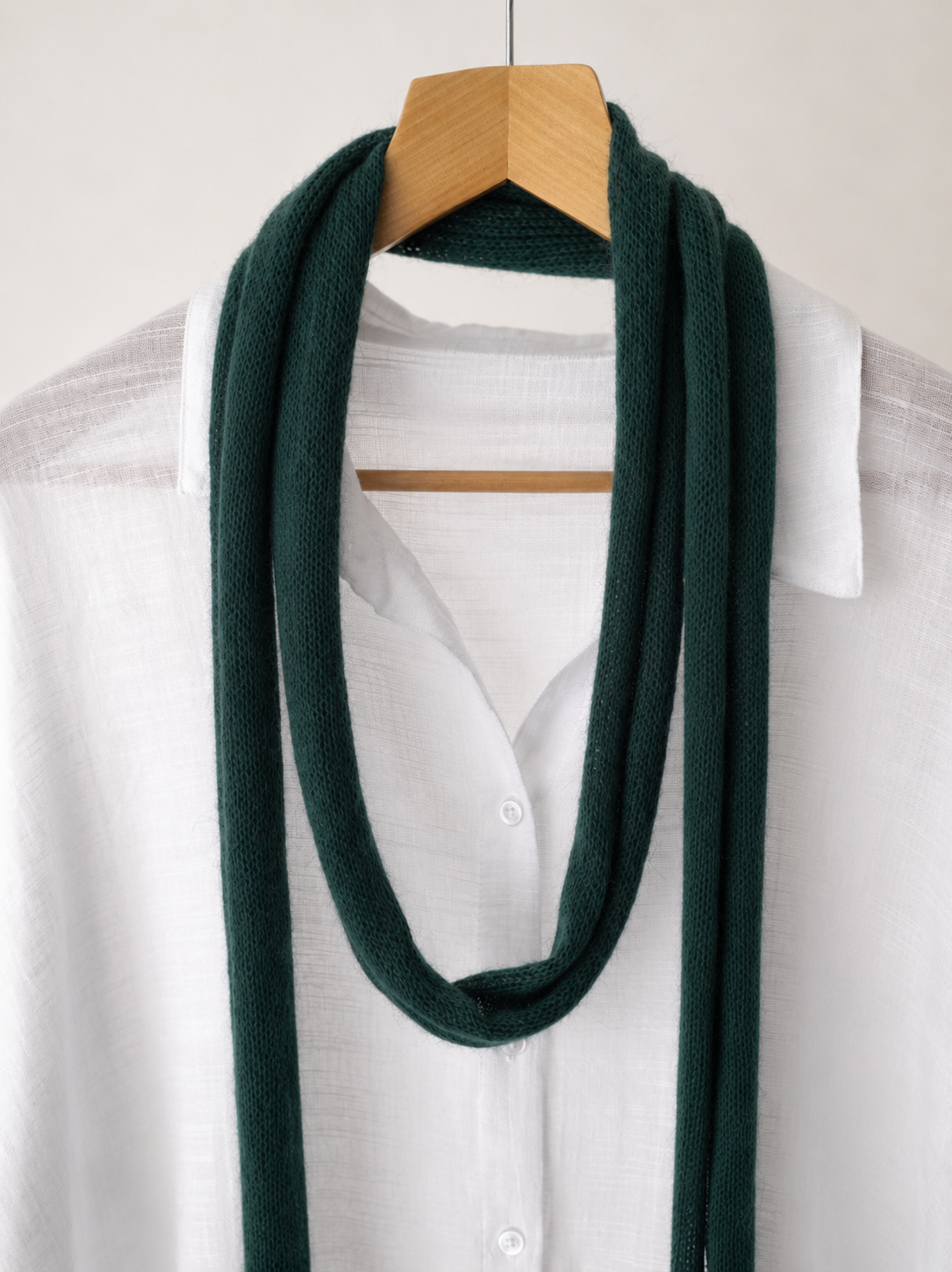 Close-up of deep forest green kid mohair scarf showing its soft knit texture.
