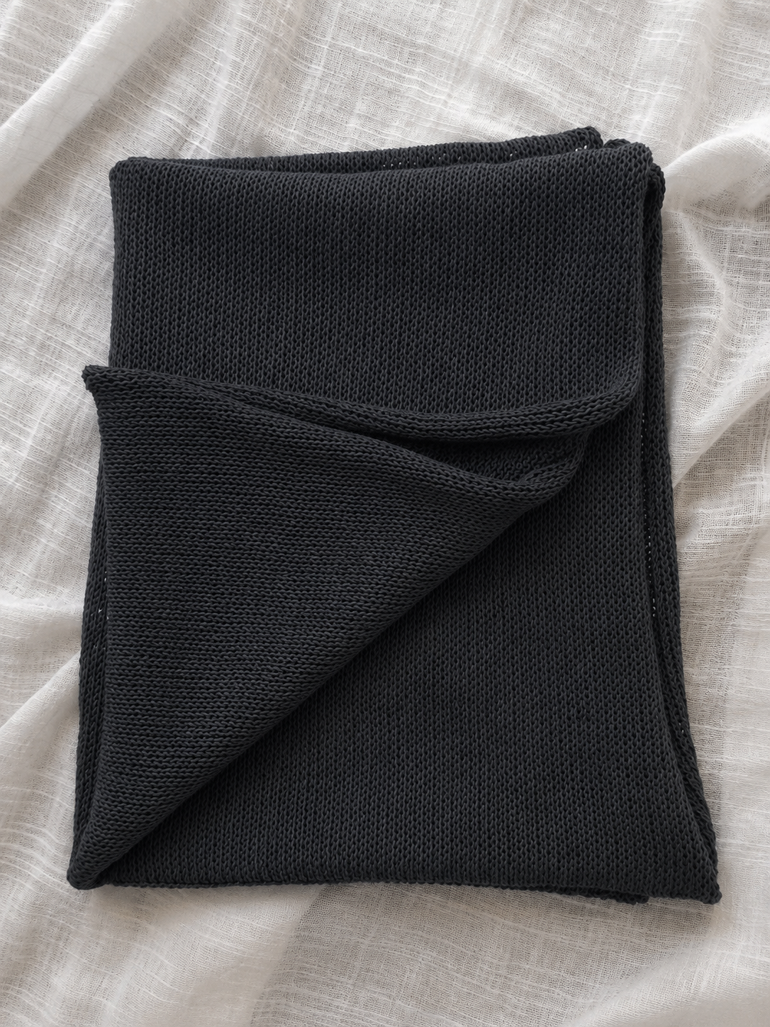 Folded Charcoal Grey linen blend scarf displaying its elegant knit texture.