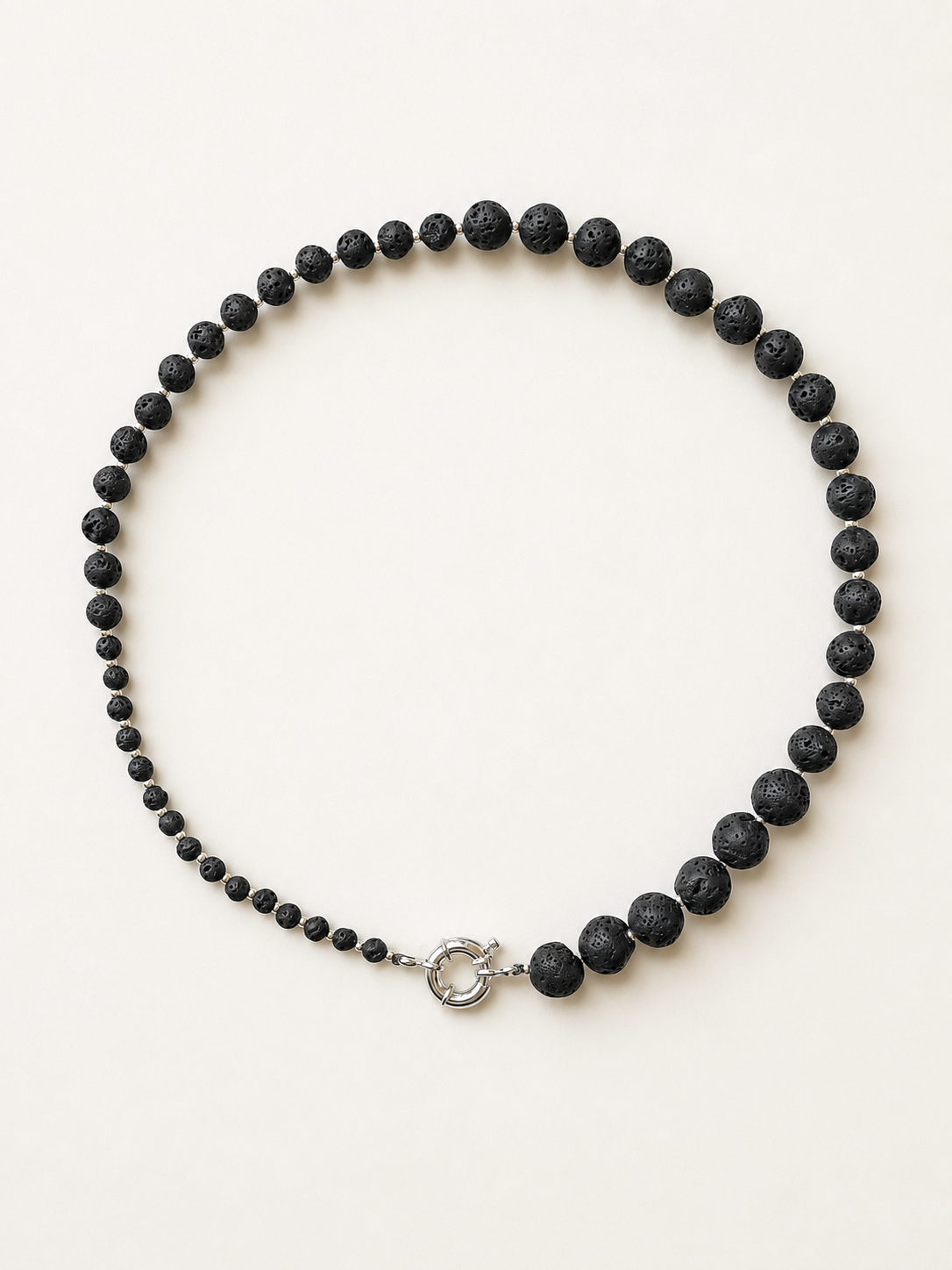 Black lava rhythm necklace with graduated stone beads and a silver-tone spring ring clasp