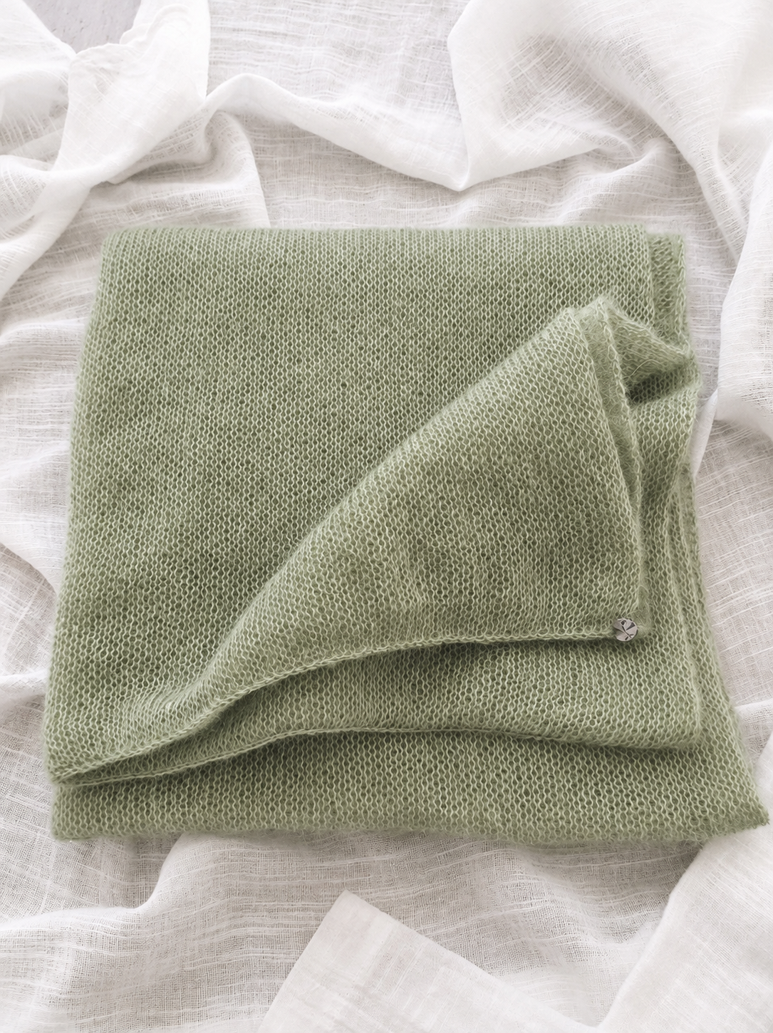 Soft Sage infinity scarf front view on white linen cloth