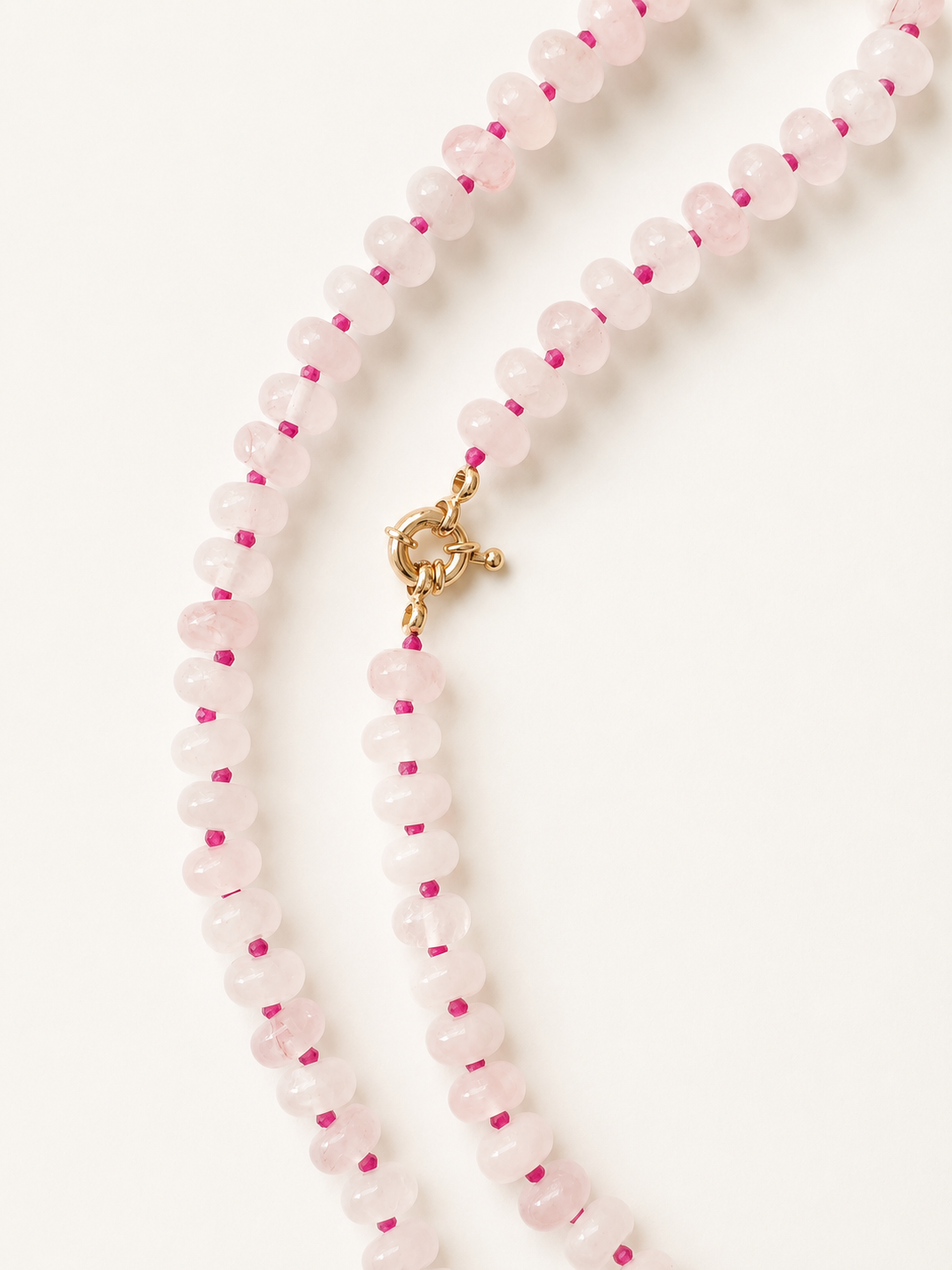 Rose quartz necklace detail showing the clasp and vivid fuchsia spacer beads