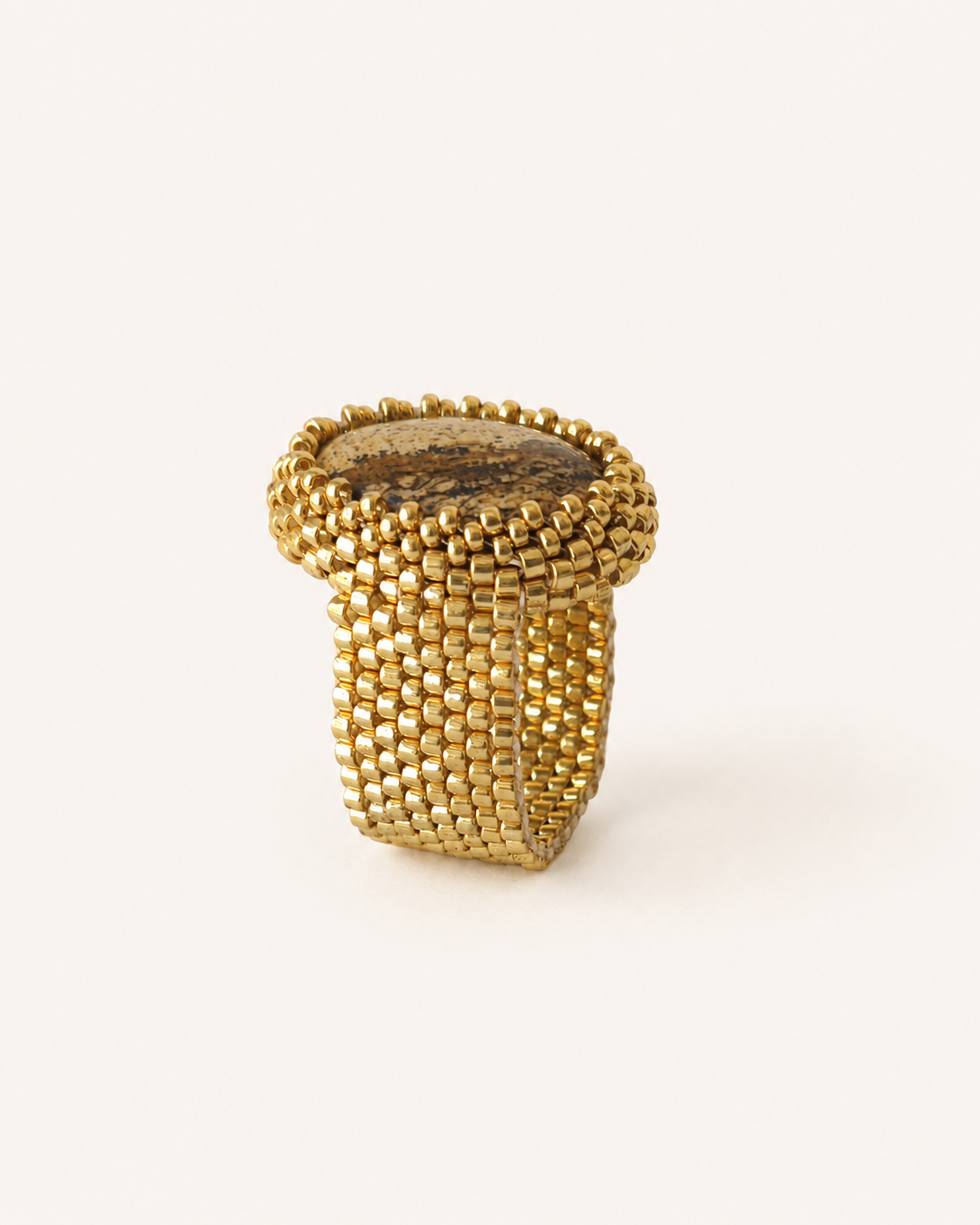 Sand jasper statement ring side profile showing oval gemstone setting and handwoven Miyuki band