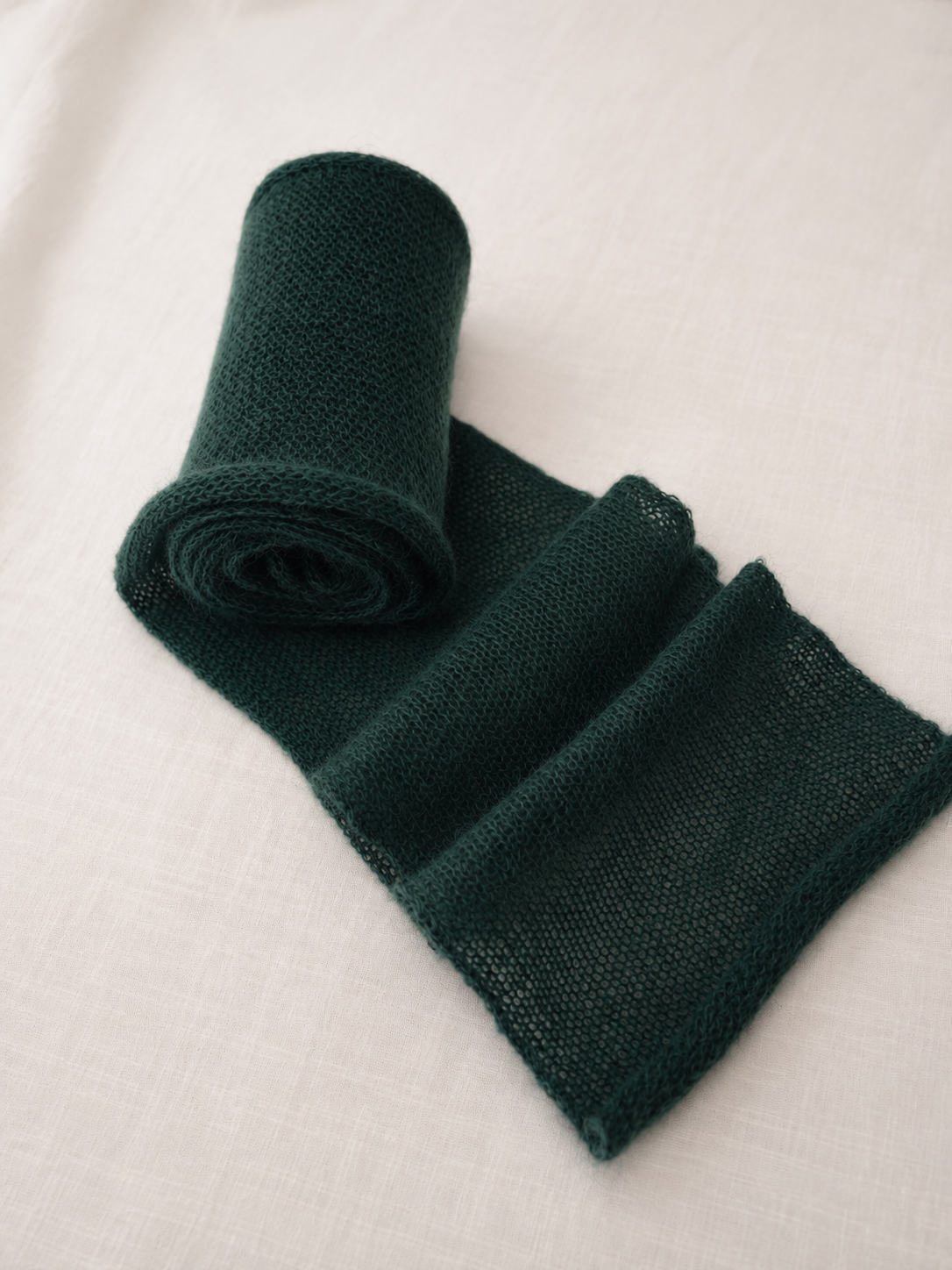 Rolled handmade deep forest kid mohair scarf.