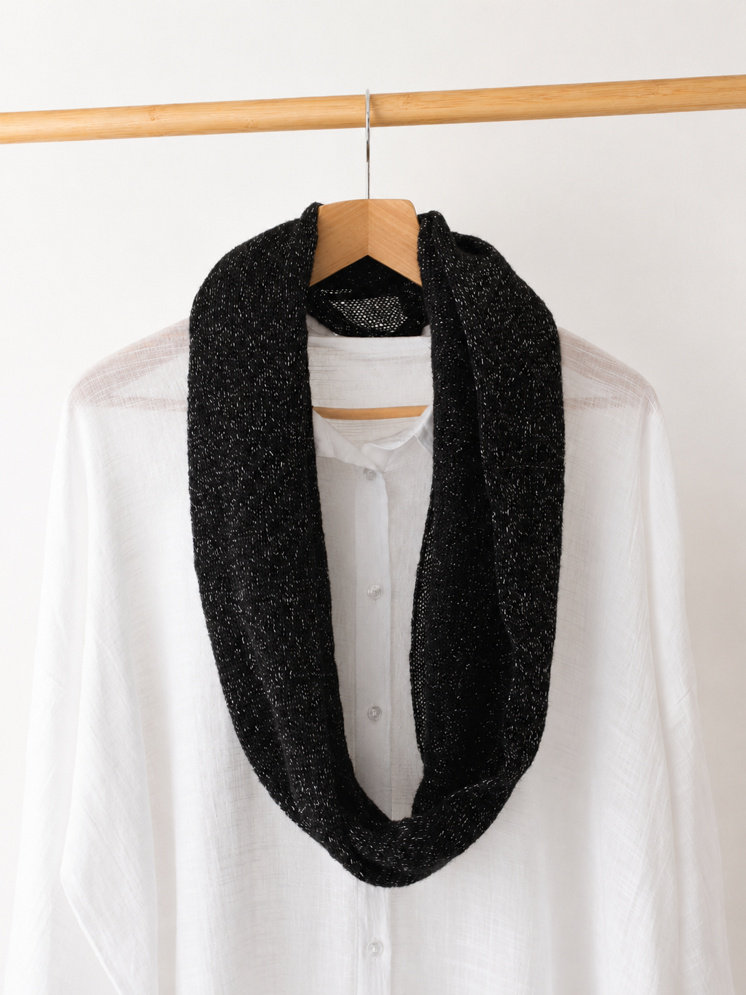 Black mohair infinity loop scarf draped over a white shirt with subtle silver shimmer