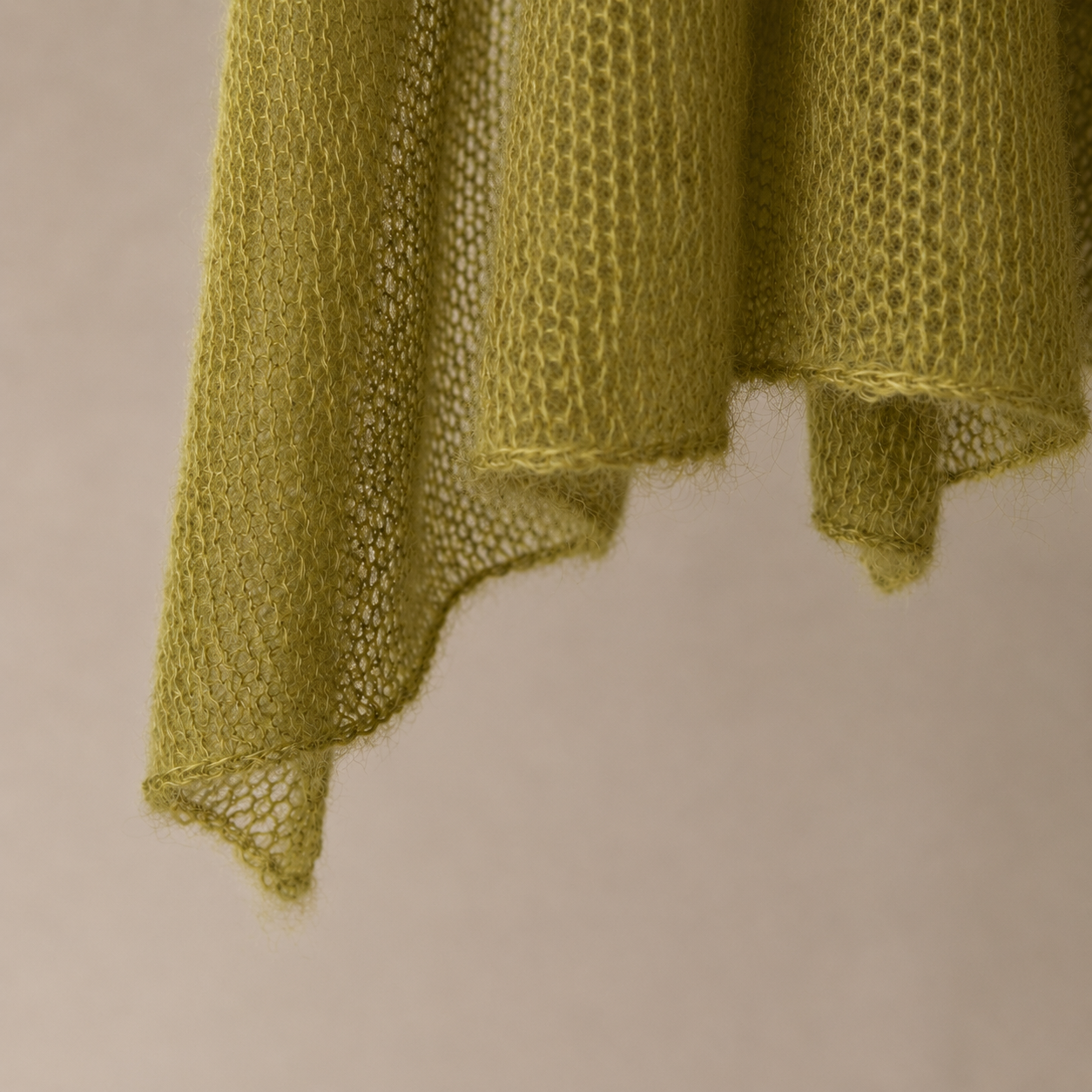 Close-up of the Moss Olive silk mohair shawl showing the fine knit and delicate edges