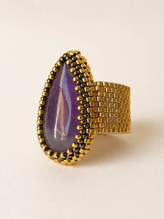 One-of-a-kind amethyst teardrop statement ring with golden Miyuki beadwork, angled view