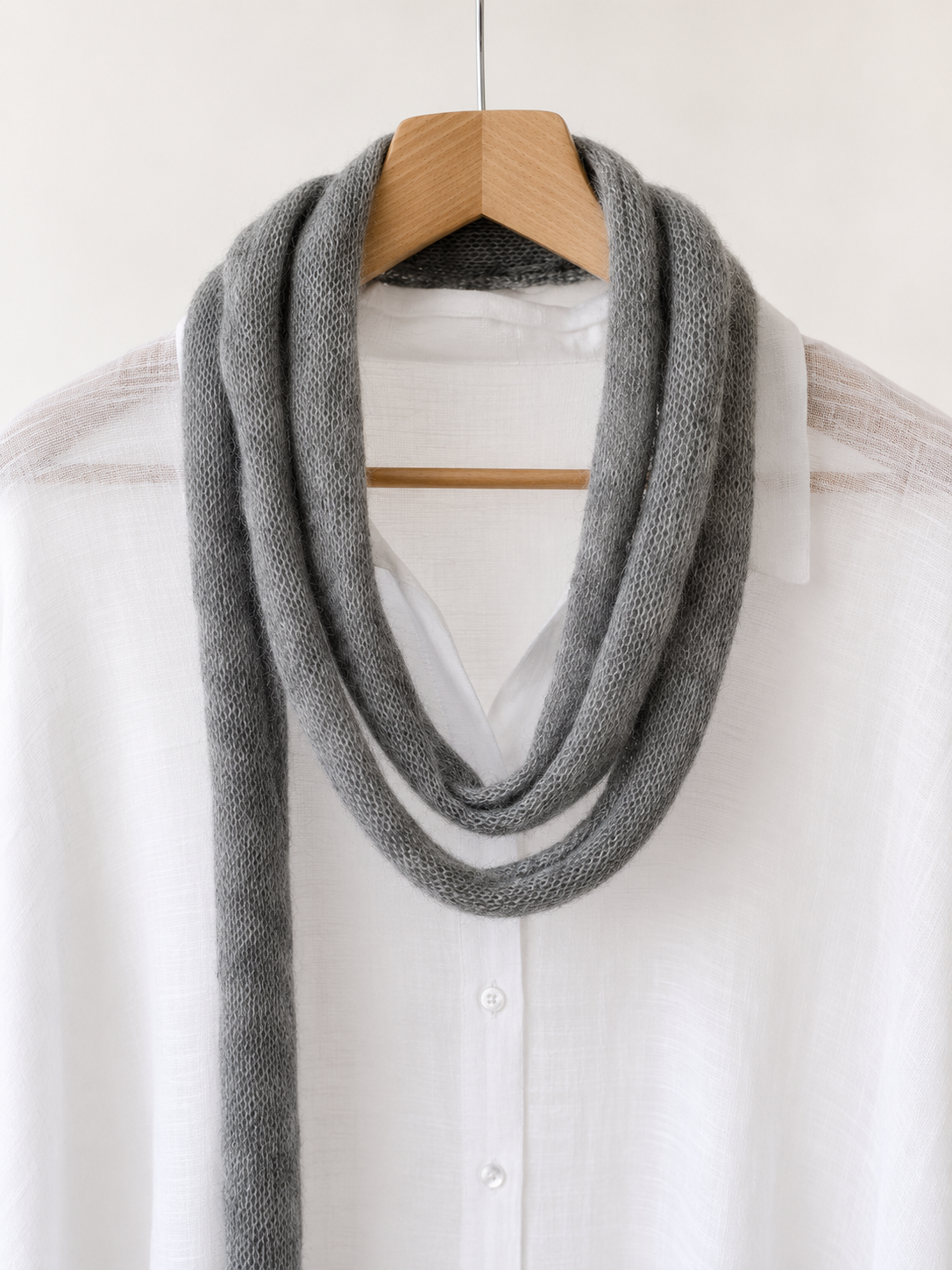 Close-up of handmade cloud grey mohair skinny scarf showing its soft airy texture.